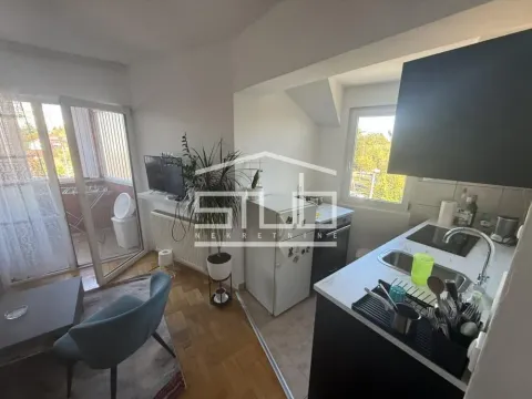 View of the kitchen connected to the living room with access to the terrace. - image 2
