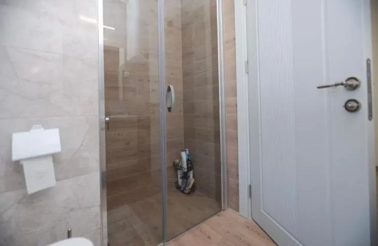 Modern equipped bathroom with a shower cabin.