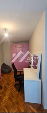 Children's bedroom with a desk, wardrobe, and laminate flooring. - image 5