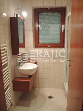 Small bathroom with a sink, mirror, and shower cabin. - image 12