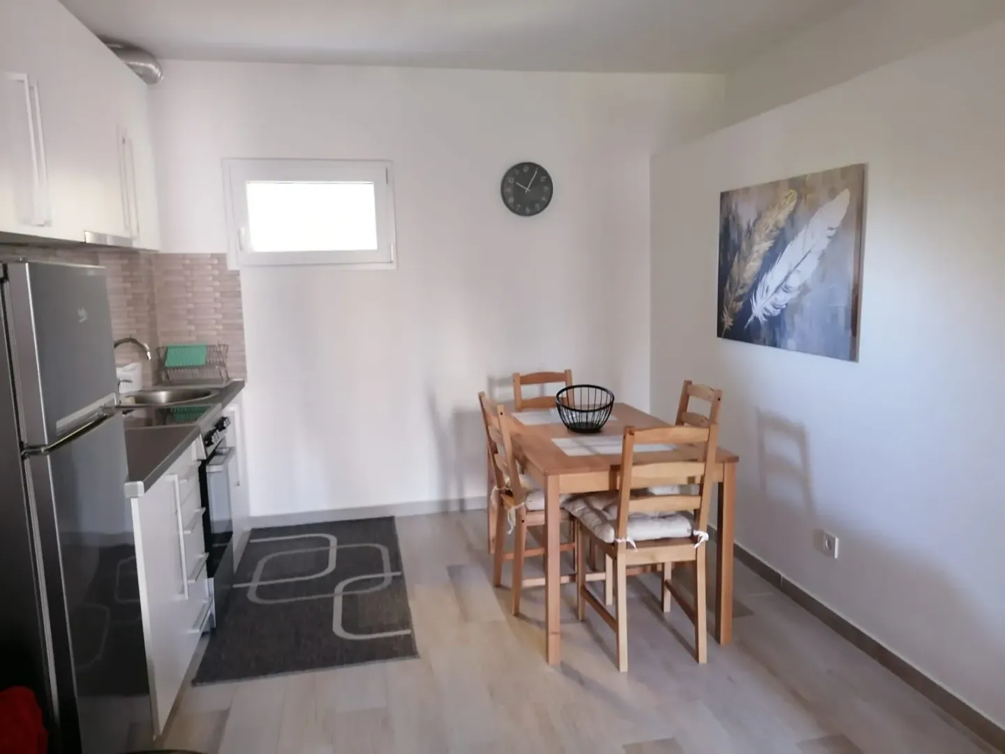 Small kitchen with a dining table and chairs.