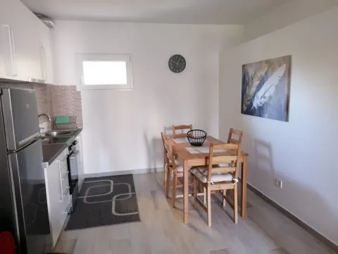 Small kitchen with a dining table and chairs. - image 8