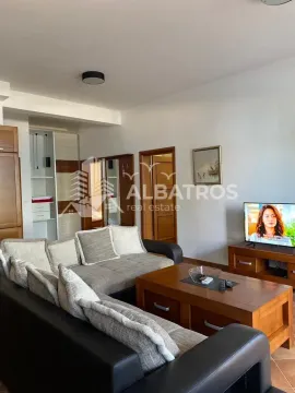 Living room with sofa, coffee table and television. - image 7