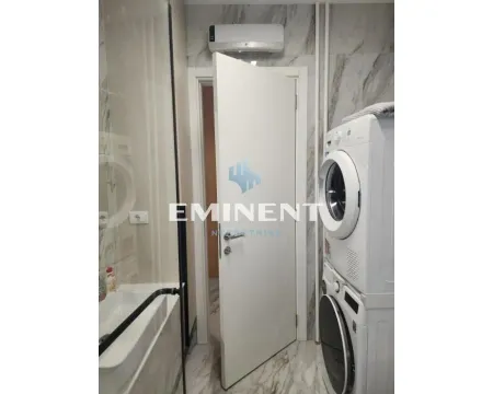 Bathroom with a walk-in shower, washbasin, and stacked washing machine and tumble dryer. - image 10