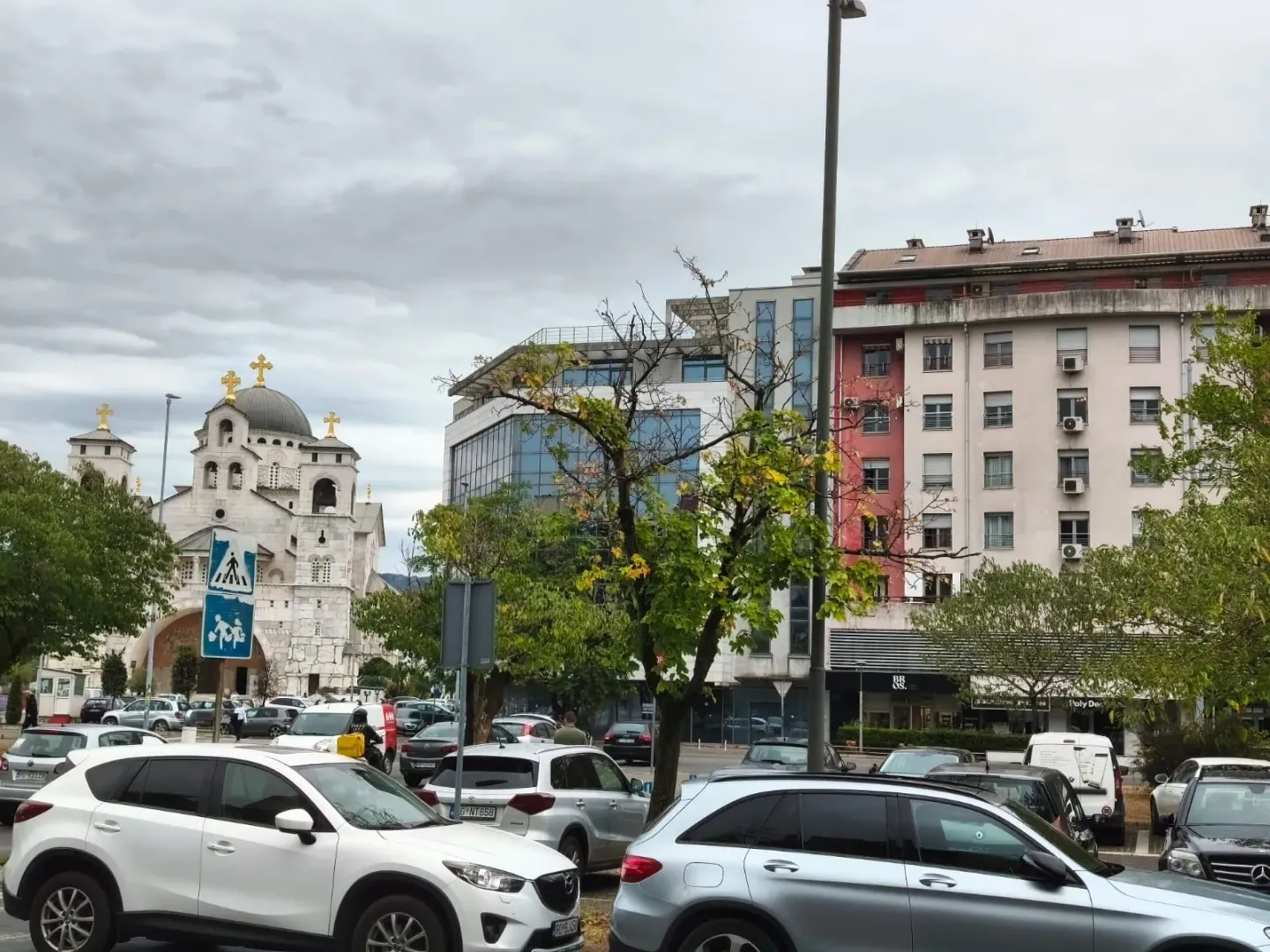 View of the city square and surrounding buildings with a parking lot in the foreground.