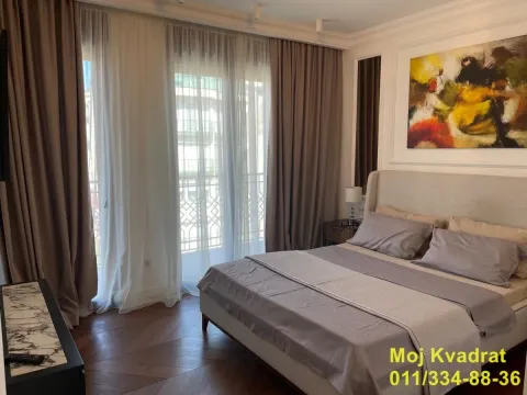 Modern bedroom with a double bed, artwork, and balcony doors with curtains. - image 9