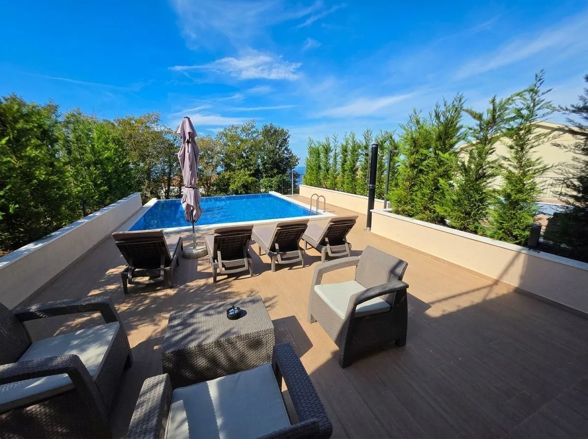 Terrace with swimming pool and patio furniture.