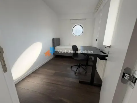 Smaller bedroom with a bed and a desk. - image 8
