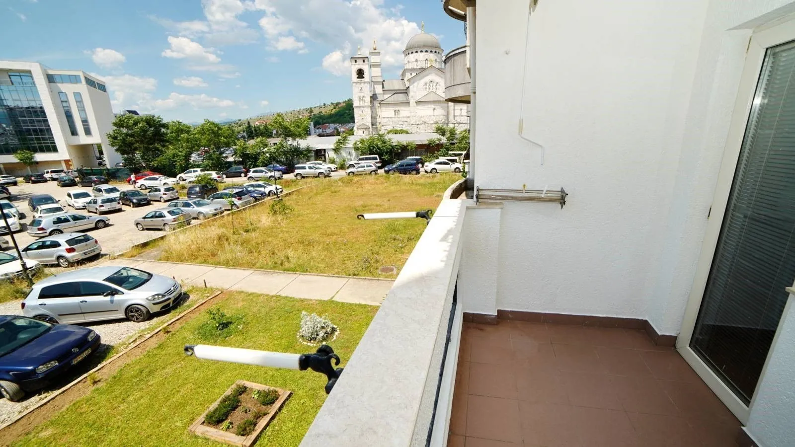 View from the balcony overlooking the surroundings and a temple in the distance.