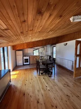 Kitchen with dining area and wooden ceiling and floor. - image 15