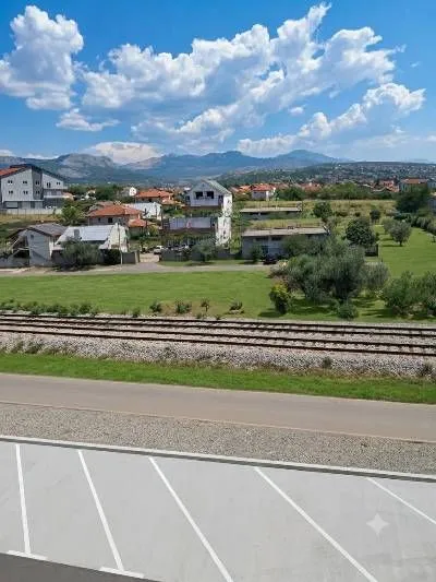 View from the property overlooking the surrounding neighborhood, railway, and distant mountains.