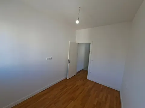 Empty room with white walls and wooden flooring. - image 11