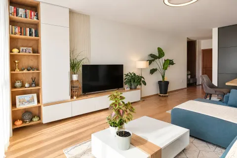 Moderan i svetao dnevni boravak sa policama za knjige i TV-om. - image 2