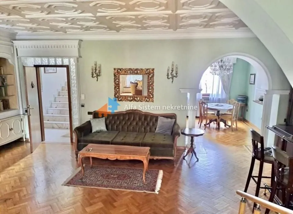 Living room with a sofa and a view of the dining area.