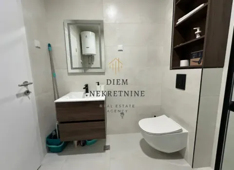 Modernly equipped bathroom with a washbasin and a toilet. - image 12
