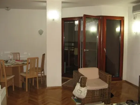 Living room with a dining table and balcony access. - image 13