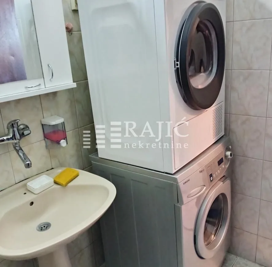 Bathroom with a sink and a washer and dryer.