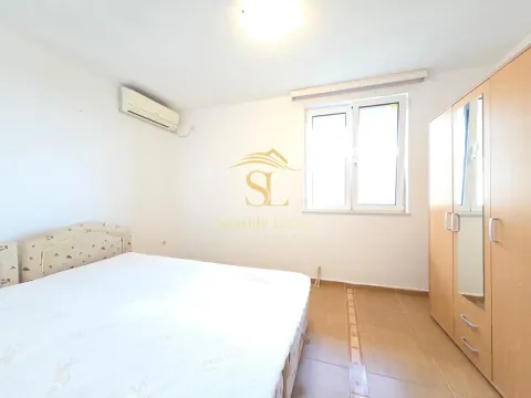 Furnished bedroom with a double bed, wardrobe, and air conditioning. - image 8