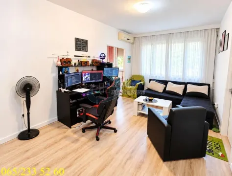 Living room with sofa set, desk, and computer setup. - image 2