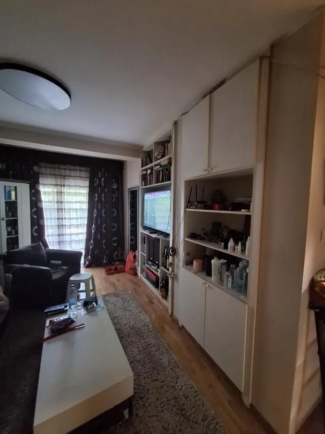 Living room with a seating area and built-in shelving.