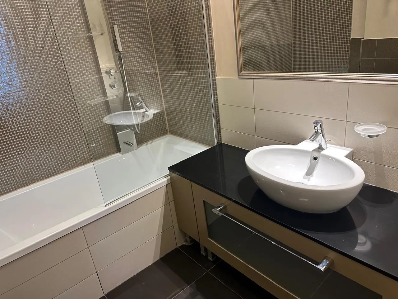 Modern bathroom with a bathtub and a stylish sink.