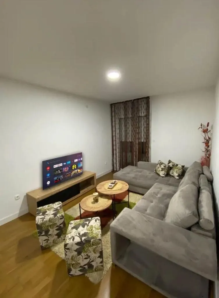 Living room with a sectional sofa, TV, and coffee table.