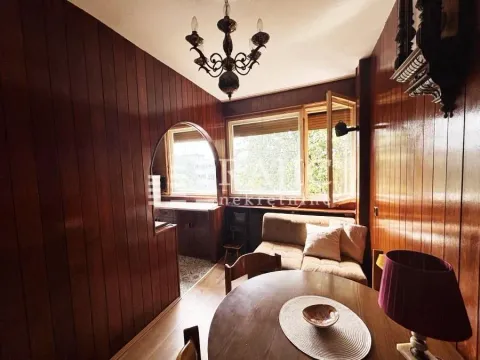 Living room with wood wall paneling and a dining table. - image 3