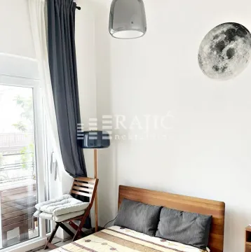 Bright bedroom with a wooden bed and access to the terrace. - image 7