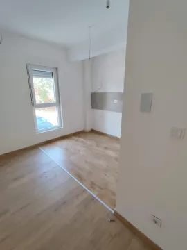 Empty room with wooden flooring and a single window. - image 6