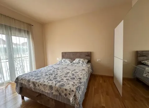 Bedroom with a double bed, wooden flooring, and balcony doors. - image 7