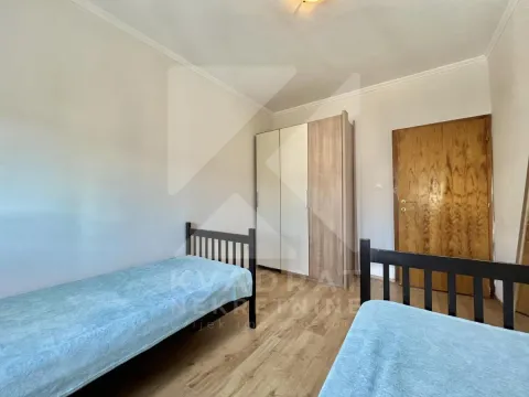 Bedroom with two single beds and a wardrobe. - image 6