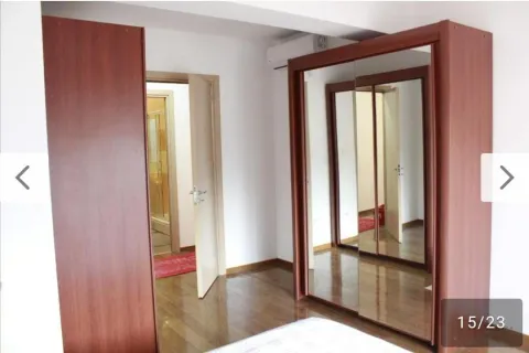 Bedroom with a large wooden wardrobe with a mirror. - image 11