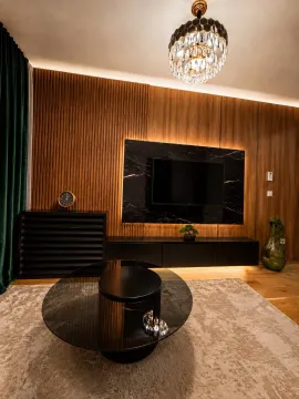 Modern and luxuriously equipped living room with wooden wall panels and a unique chandelier. - image 2