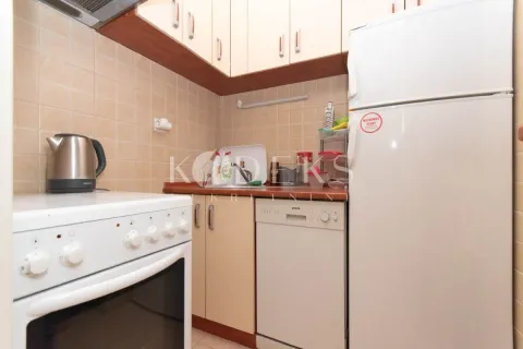 Smaller kitchen with a stove, refrigerator, and cabinetry. - image 4