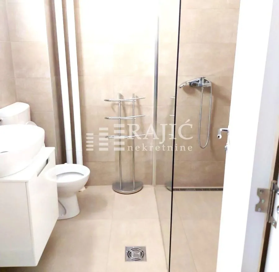 Modern bathroom with walk-in shower and sanitary ware.