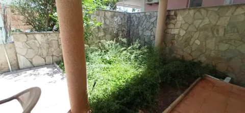 Yard with a stone wall and columns. - image 12