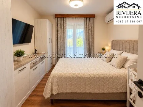 Furnished bedroom with a double bed, wardrobe, and TV. - image 8