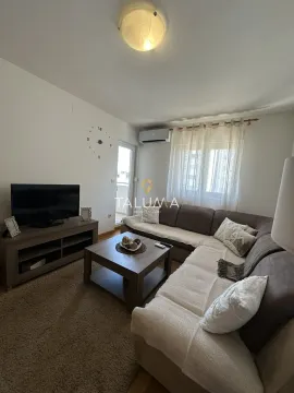 Living room with a sofa, TV, and access to the terrace. - image 2