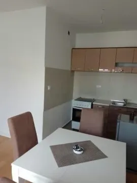 Small kitchen with a dining table and chairs. - image 3
