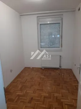 Empty room with parquet flooring and a single window. - image 5