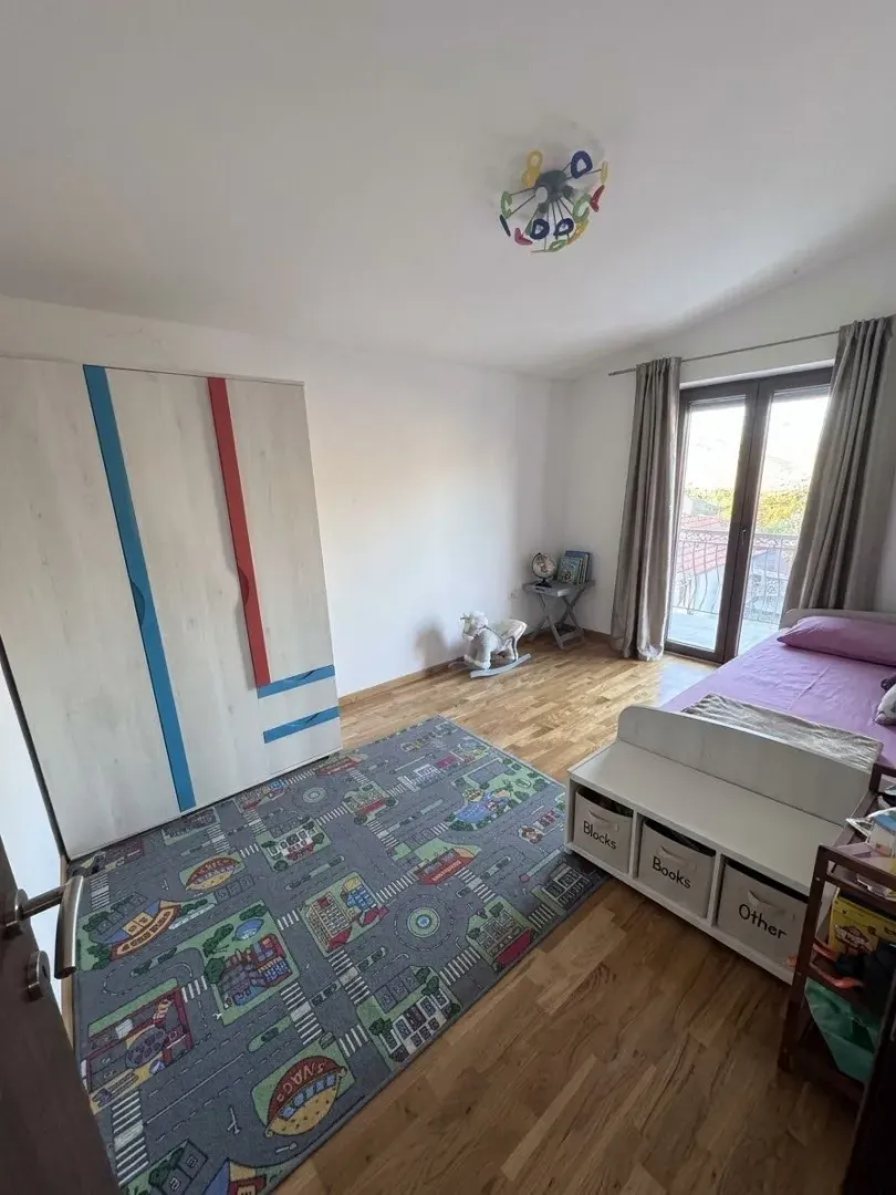 Children's bedroom with a bed, wardrobe, and toys.
