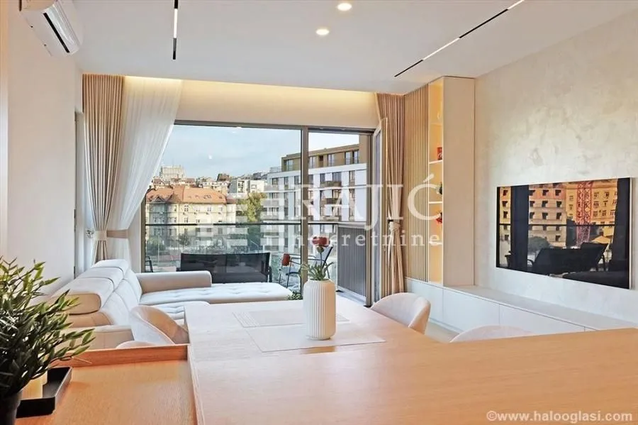 Modern living room with sofa and city view.
