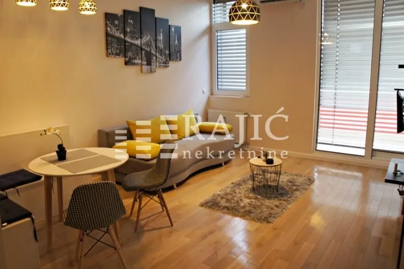 Living room with dining area and modern furniture.