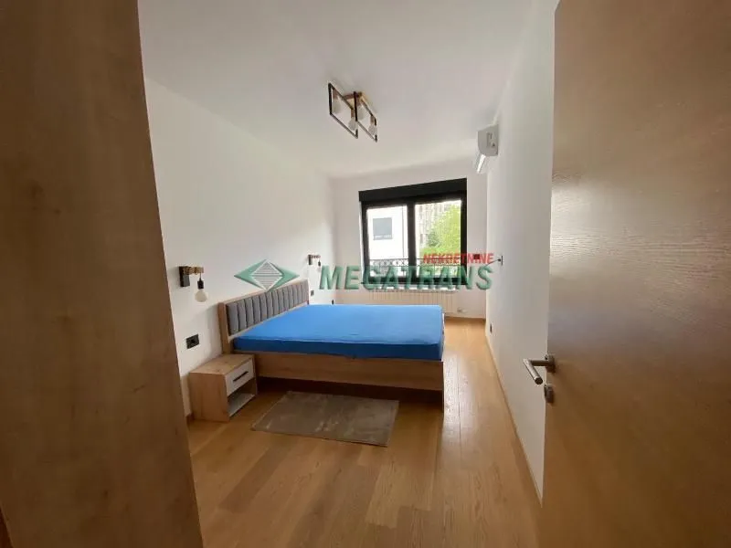 Furnished bedroom with a double bed and a nightstand.