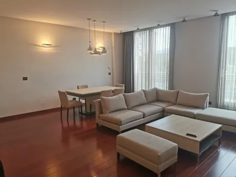 Spacious living room with a corner sofa and a dining table. - image 3