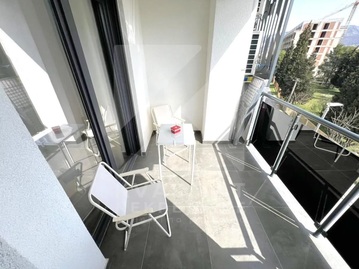 Modern balcony with seating furniture and a view of the surroundings.