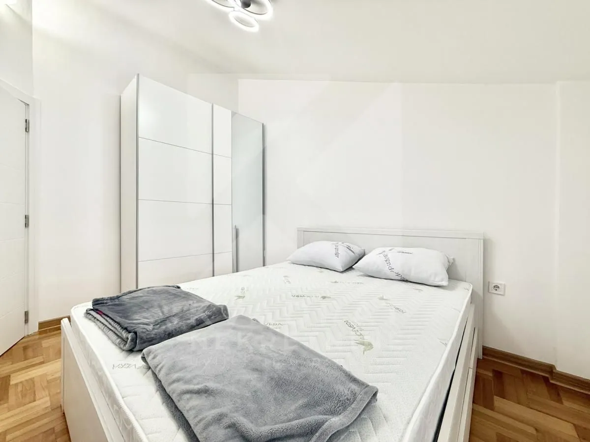 Bedroom with a double bed and a white wardrobe.