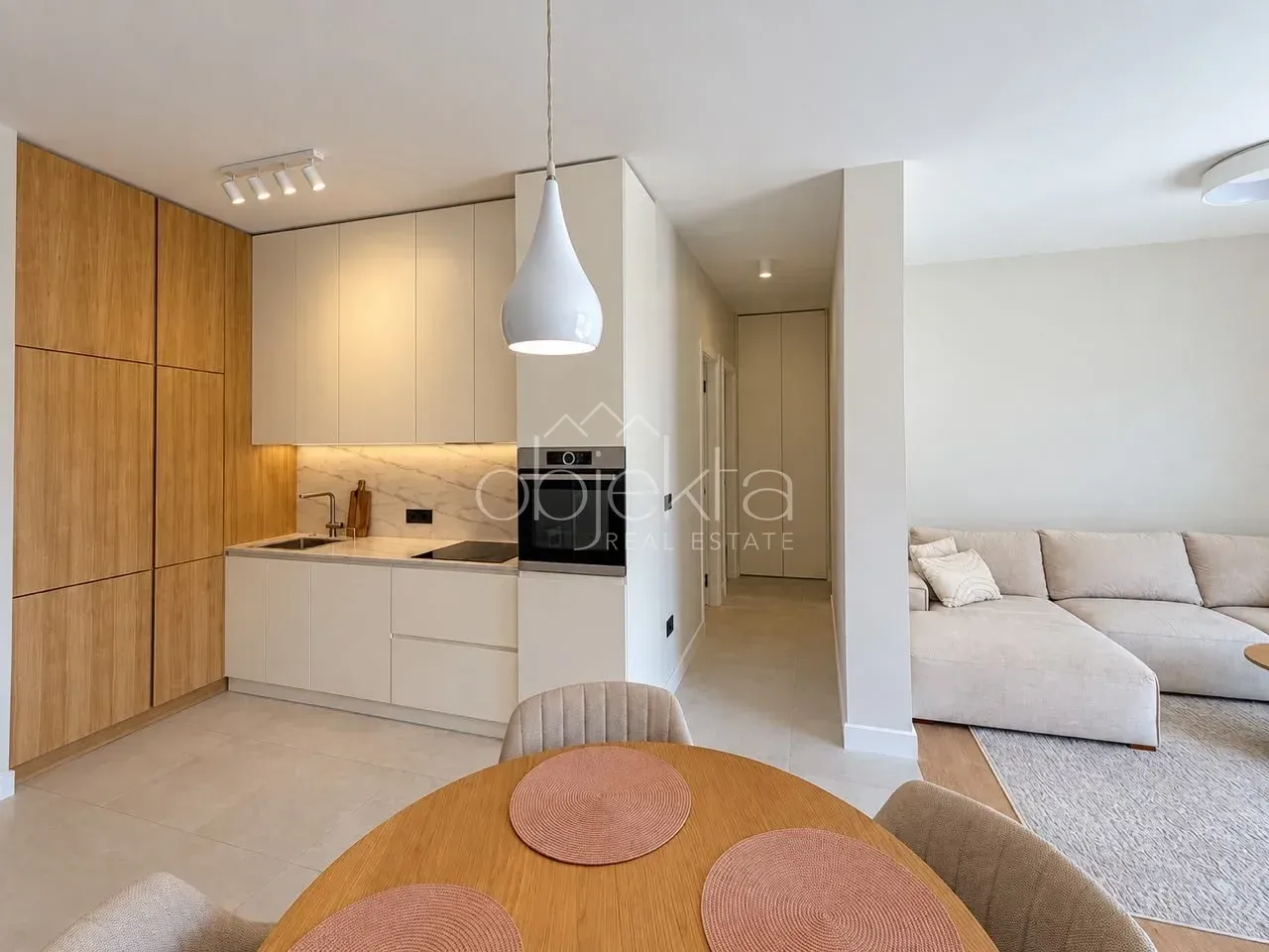 Modern living room with kitchen and dining area.