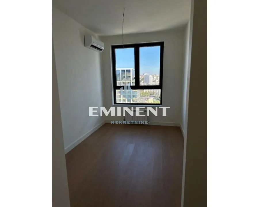 Empty room with a window and an air conditioning unit.