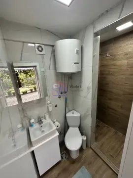 Modernly equipped bathroom with a shower cabin and water heater. - image 11